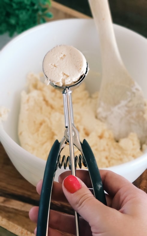 Premium Photo  Hand stirring the mixture in mixing bowl with spoon for  baking brazilian cheese bread