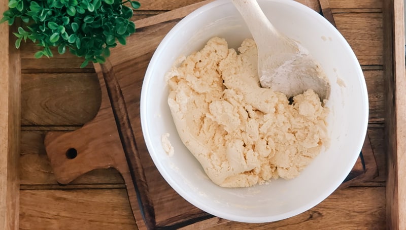 Premium Photo  Hand stirring the mixture in mixing bowl with spoon for  baking brazilian cheese bread