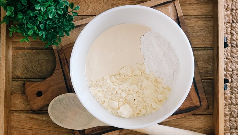 Premium Photo  Hand stirring the mixture in mixing bowl with spoon for  baking brazilian cheese bread